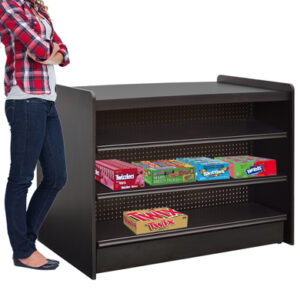  A woman in a plaid shirt and jeans stands next to a black candy display shelf with three shelves, each holding various candy boxes, including Twizzlers, Skittles, and Nerds. The shelf features a pegboard back and a smooth top surface.