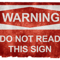 The image is a warning sign with a red background and white text. The text reads: "WARNING: DO NOT READ THIS SIGN. Funny