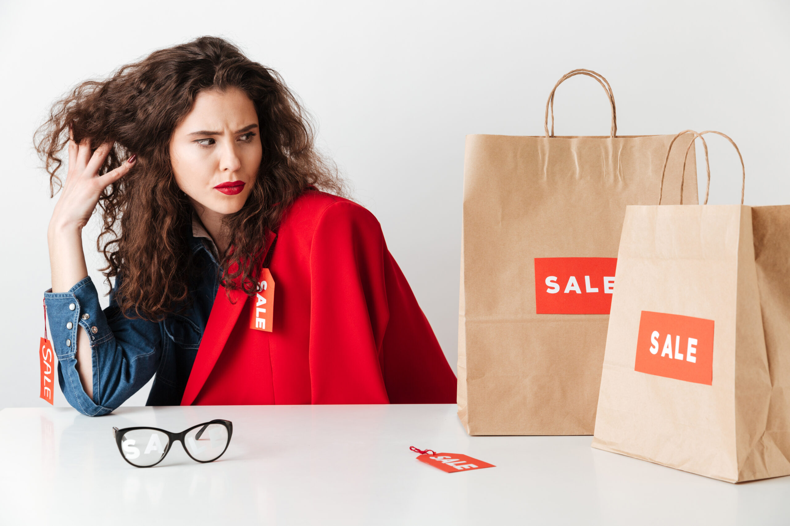 an image of a woman looking at a sale with discontempt